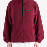 Burgundy jacket worn by a person, showing the jacket fit