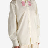 White shirt worn by a person, showing the shirt's fit