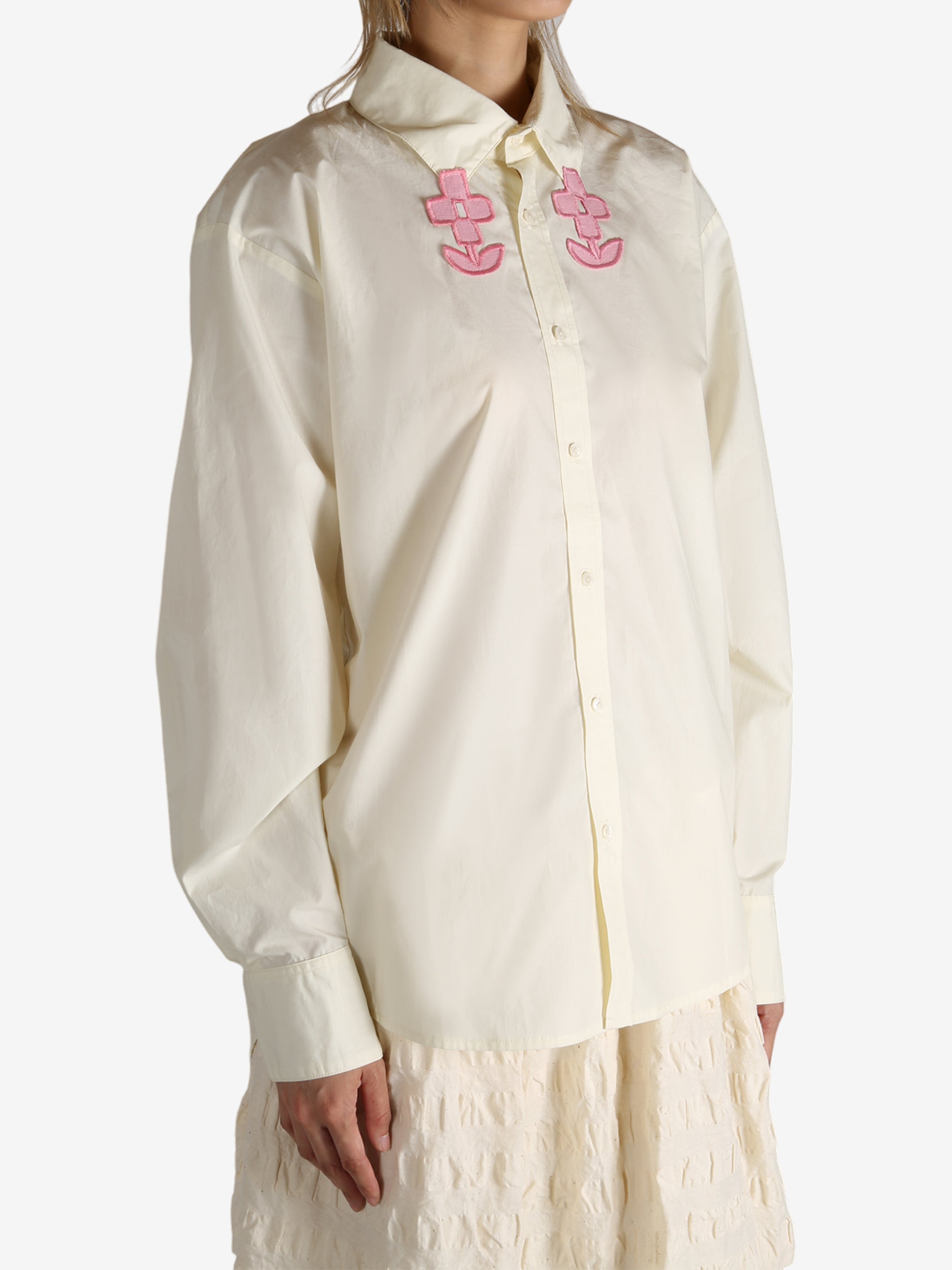 White shirt worn by a person, showing the shirt's fit