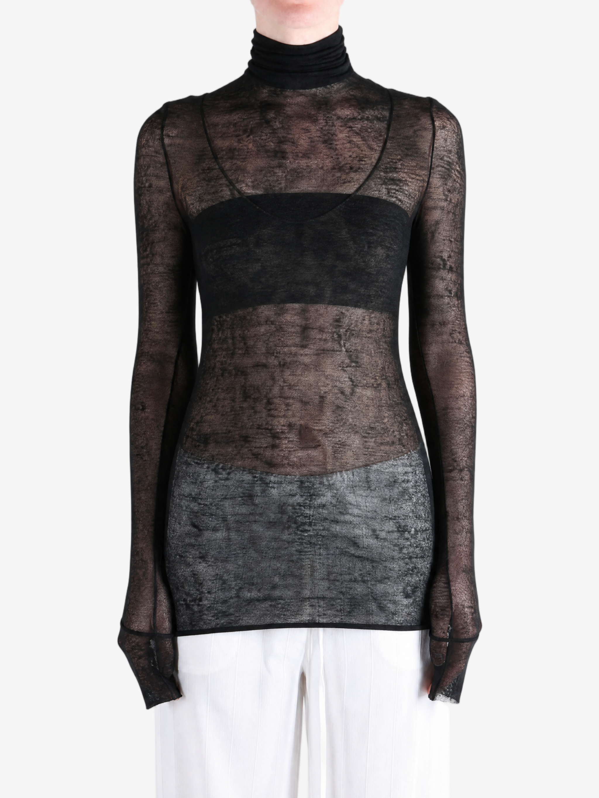 Black top worn by a person, showing the top fit
