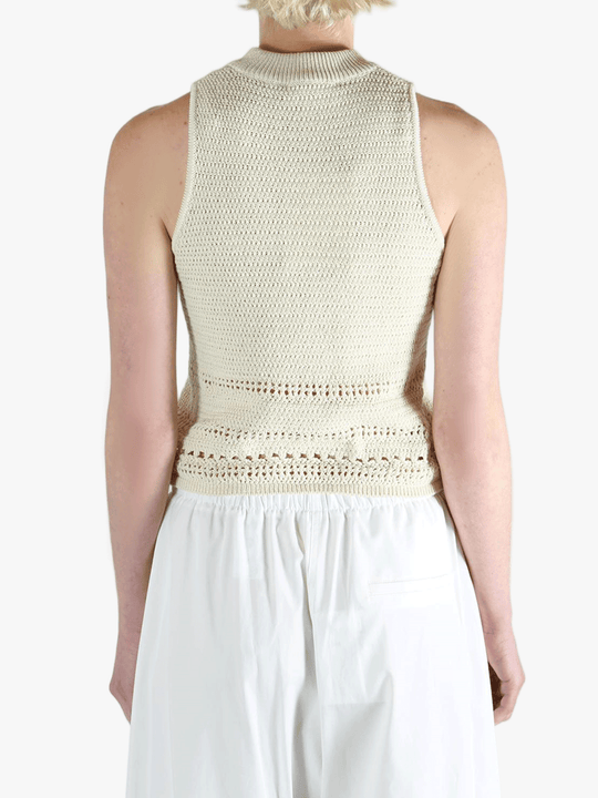 White vest worn by a person, showing the vest's fit