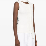 White top worn by a person, showing the top's fit