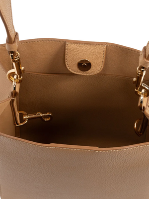 Close up of tan bag, showing texture of the leather fabric