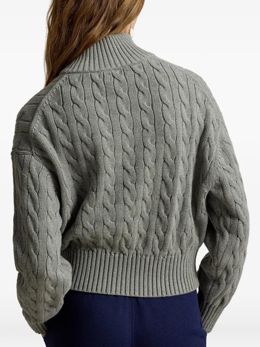 Grey knitwear worn by a person, showing the knitwear fit
