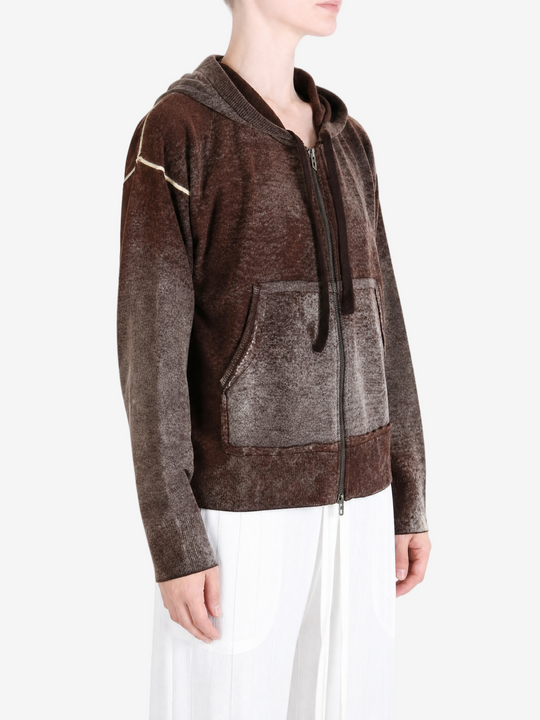 Brown hoodie worn by a person, showing the hoodie fit