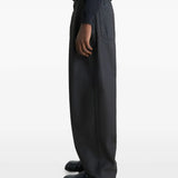 Black pants worn by a person, showing the pants' fit