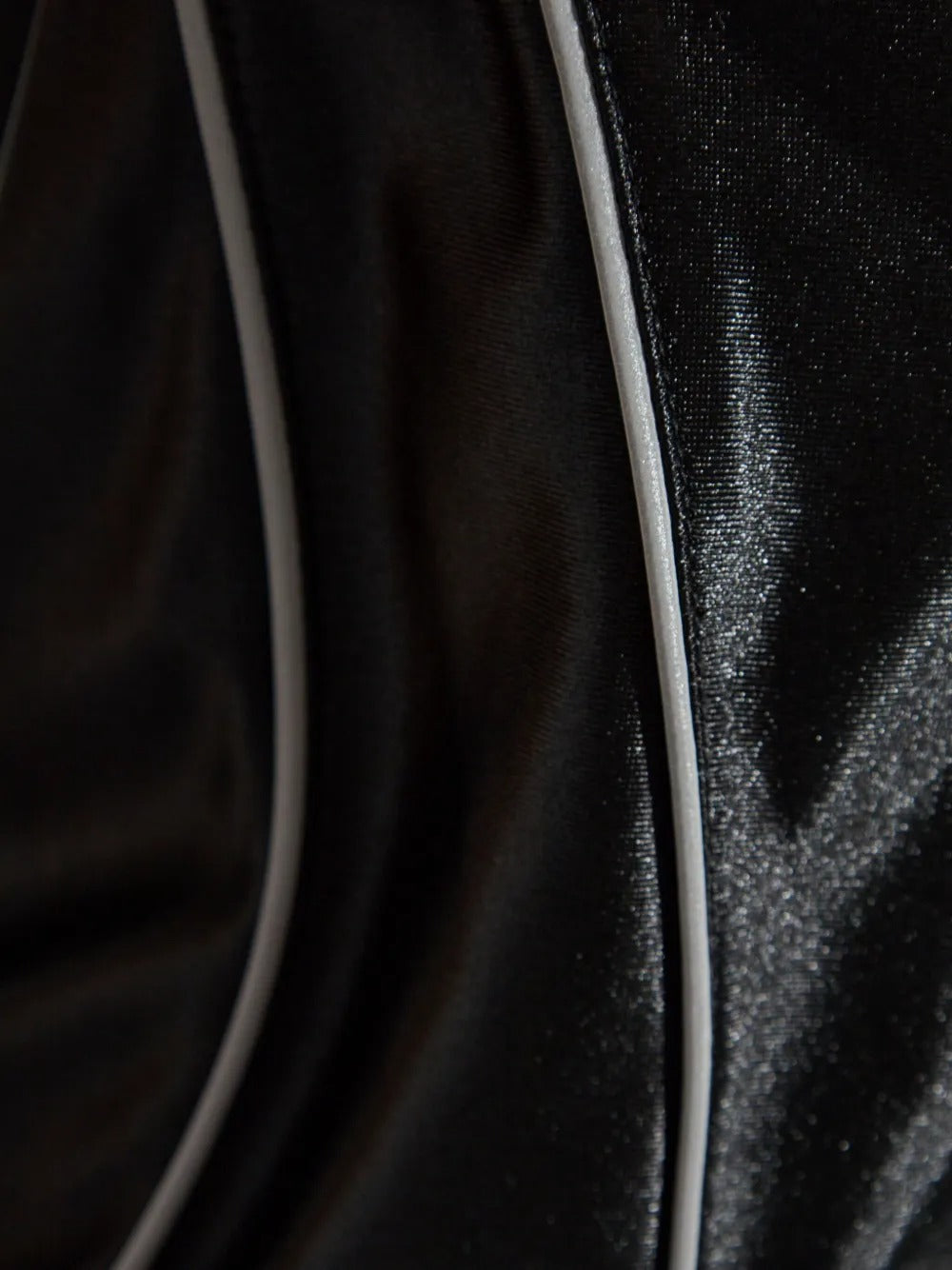 Close up of black tops, showing texture of the polyester fabric