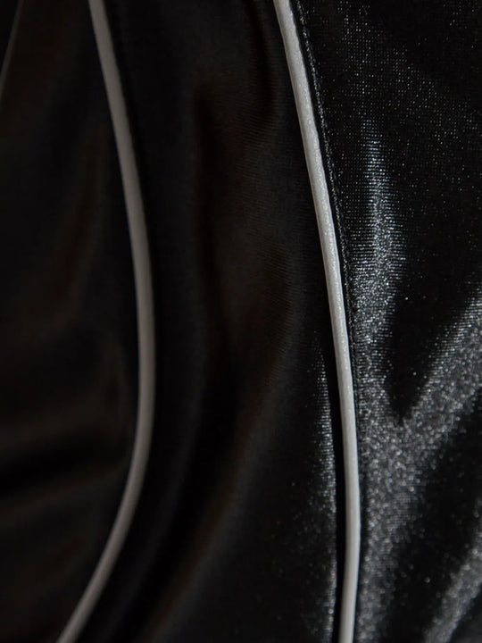 Close up of black tops, showing texture of the polyester fabric