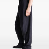 Black pants worn by a person, showing the pants' fit