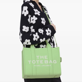 Green bags worn by a person, showing the bags fit