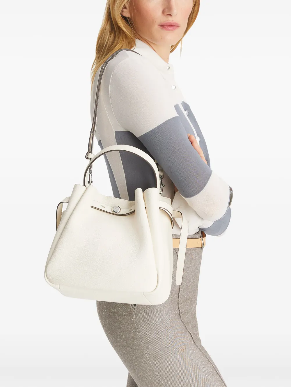 White bag on the back by a person, showing the bag fit