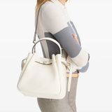 White bag on the back by a person, showing the bag fit