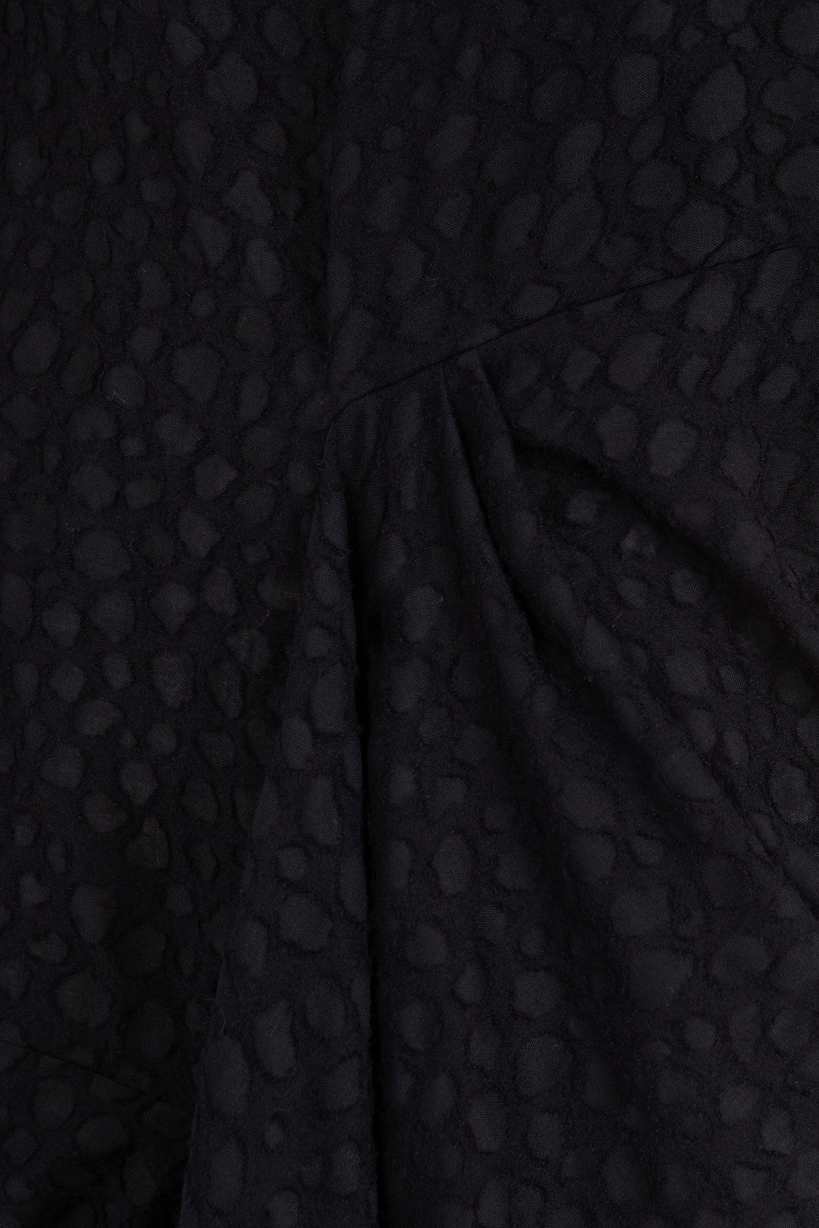 Close up of Black dress, showing texture of the 100% virgin wool made fabric