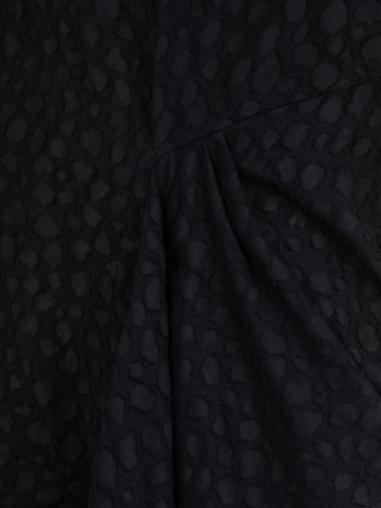 Close up of Black dress, showing texture of the 100% virgin wool made fabric