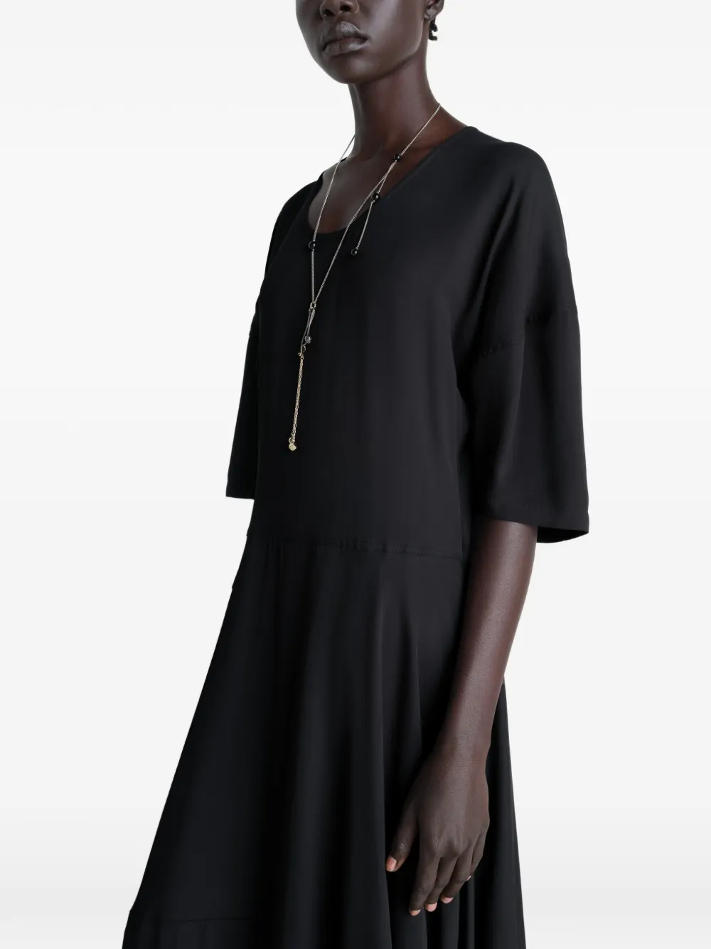 Black dress worn by a person, showing the dress fit