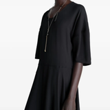 Black dress worn by a person, showing the dress fit