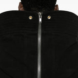 Black jacket worn by a person, showing the jacket fit