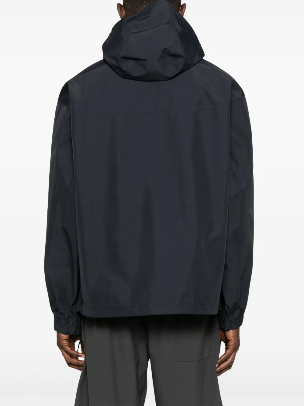 Black jacket worn by a person, showing the jacket's fit