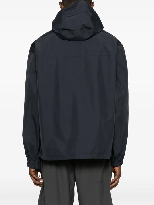 Black jacket worn by a person, showing the jacket's fit