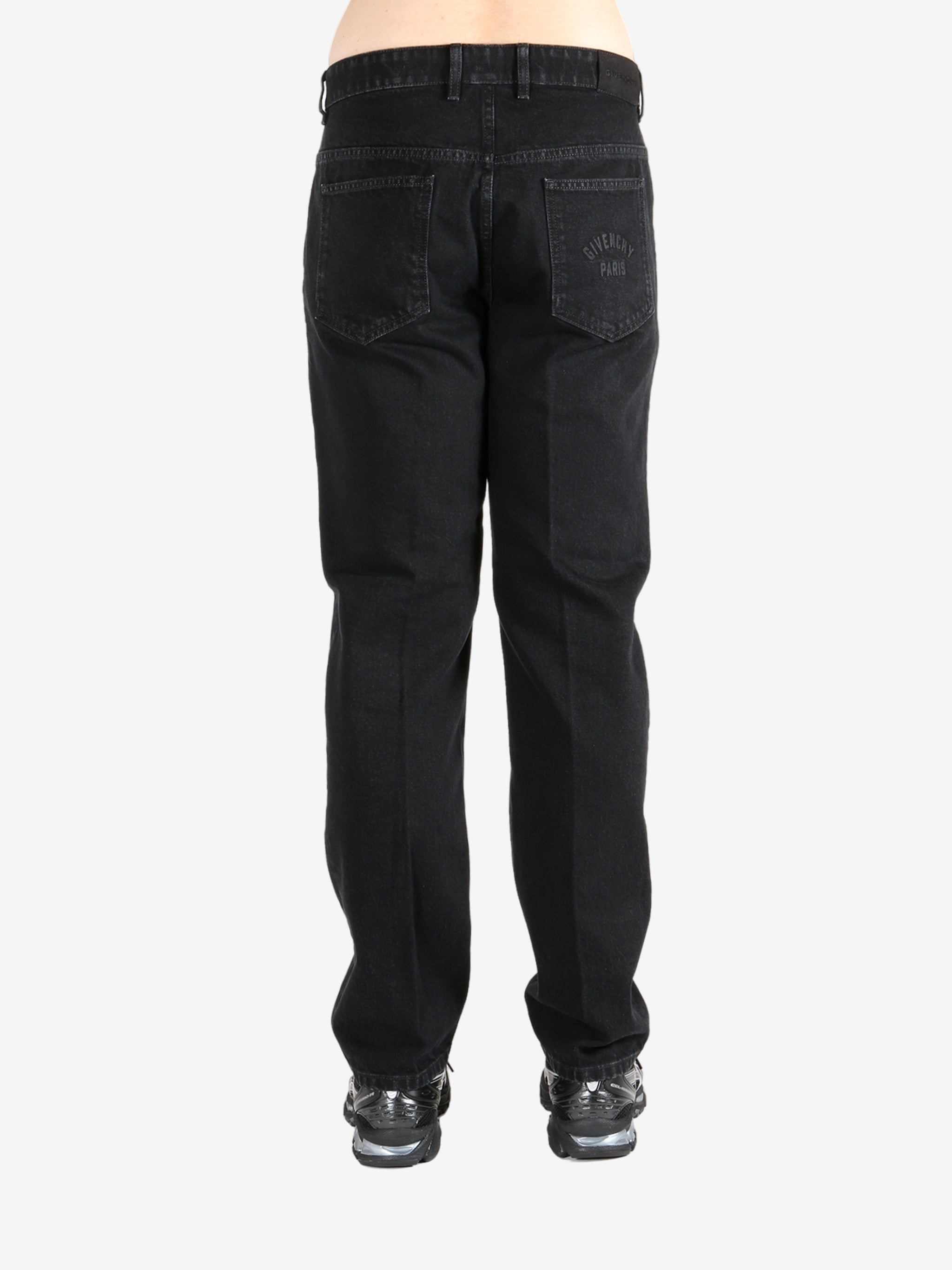 Black pants worn by a person, showing the pants's fit