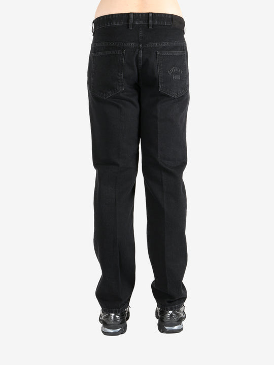 Black pants worn by a person, showing the pants's fit