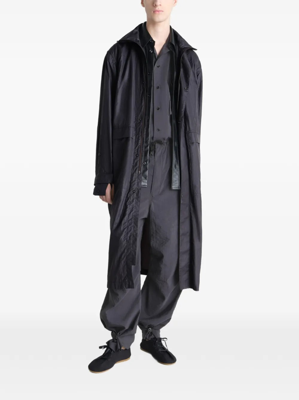 Black coat worn by a person, showing the coat's fit