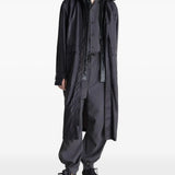 Black coat worn by a person, showing the coat's fit