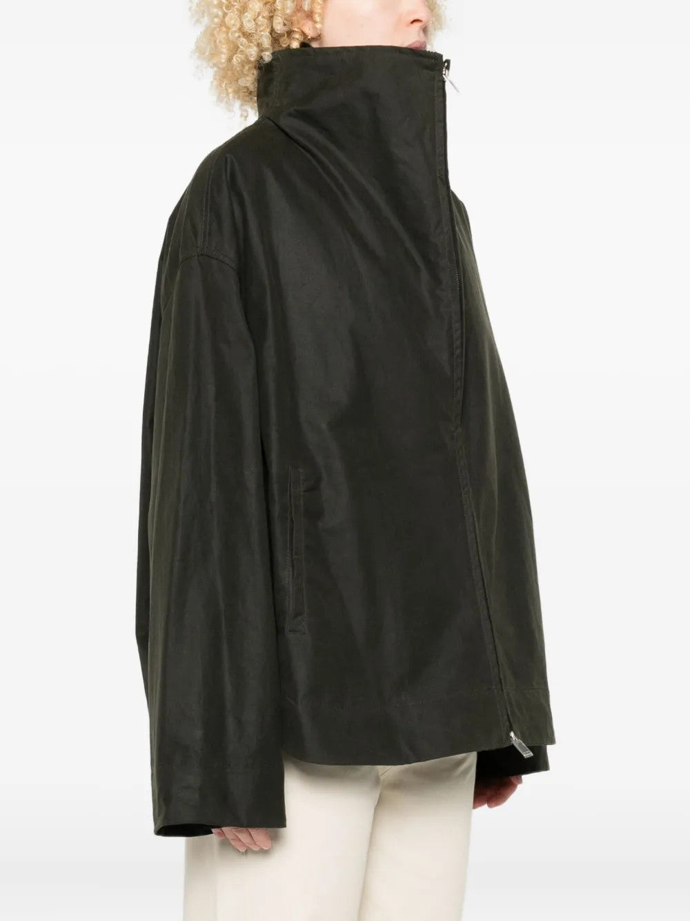 Green jacket worn by a person, showing the jacket fit