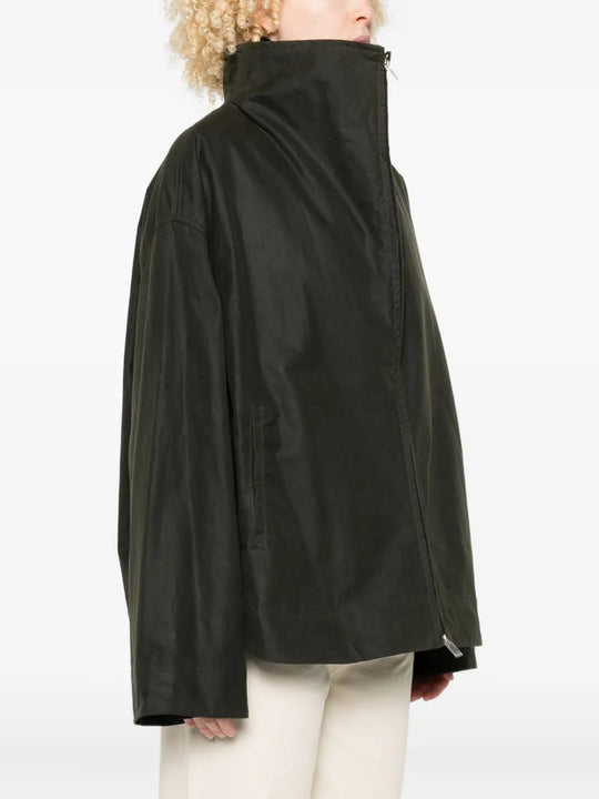 Green jacket worn by a person, showing the jacket fit