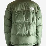 Green jacket worn by a person, showing the jacket's fit