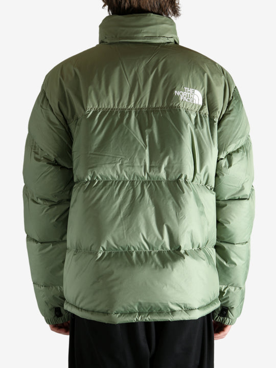 Green jacket worn by a person, showing the jacket's fit