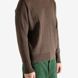 Brown knitwear worn by a person, showing the knitwear's fit