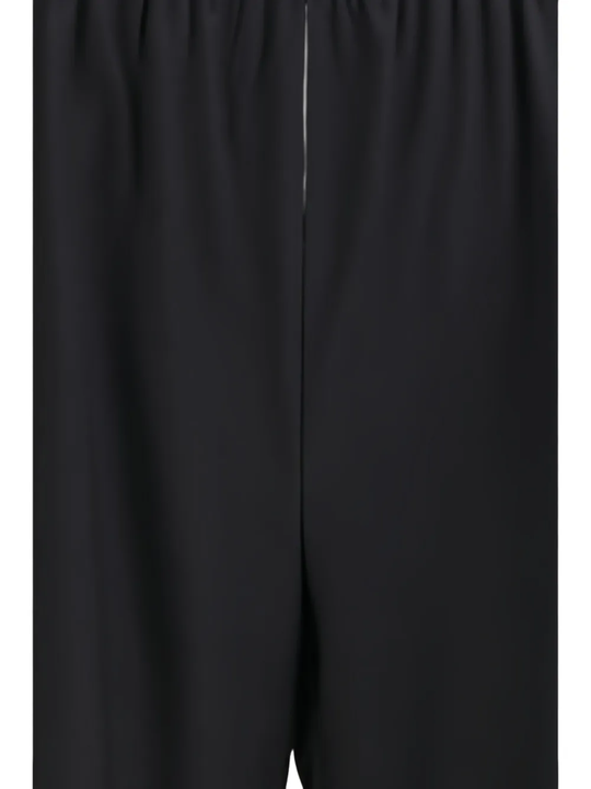 Close up of black pants, showing texture of the virgin wool fabric