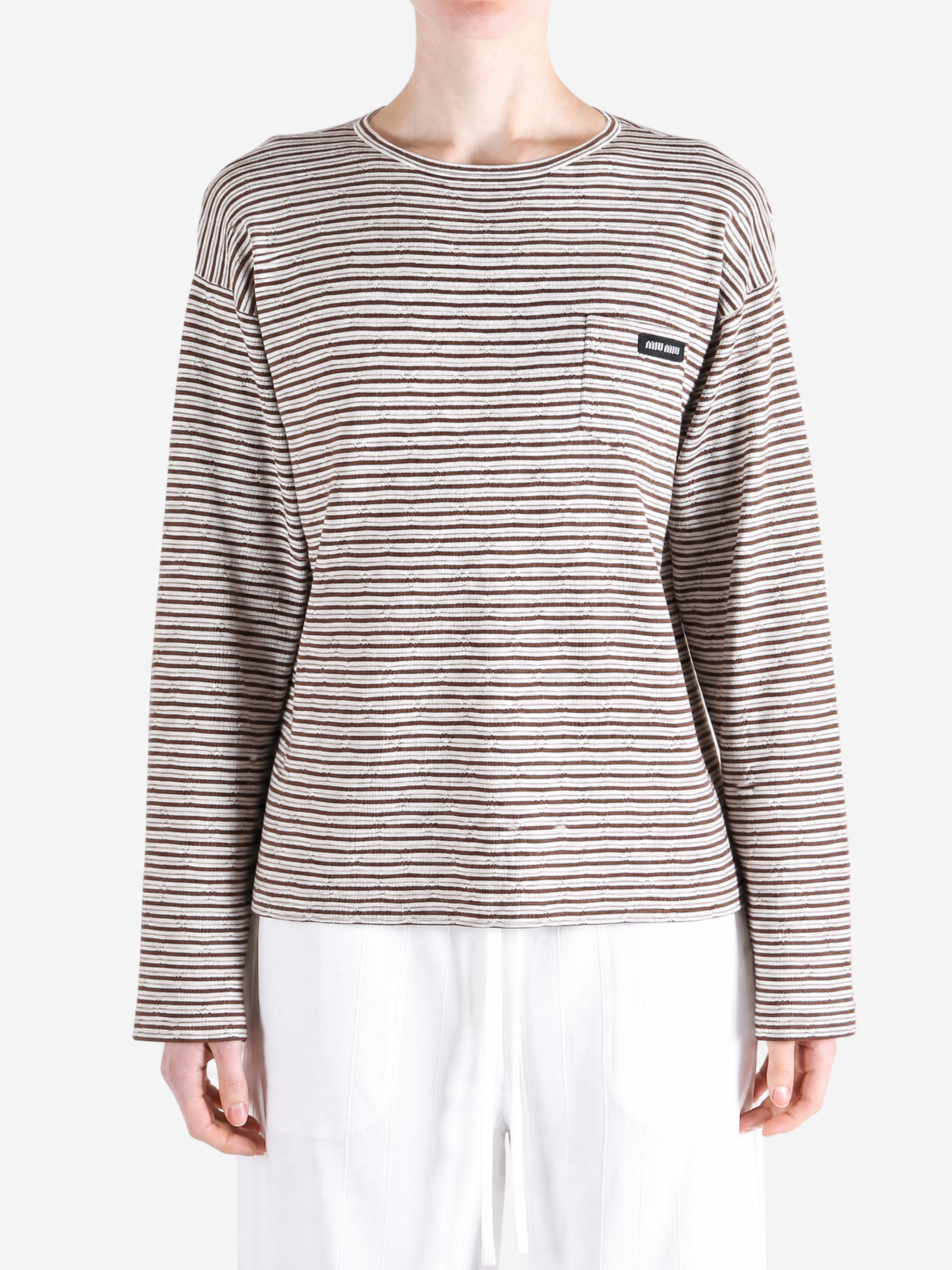 Brown knitwear worn by a person, showing the knitwear fit