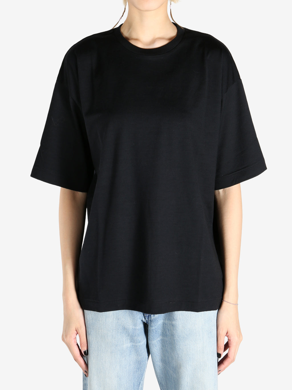 Black T-shirt worn by a person, showing the shirt's fit