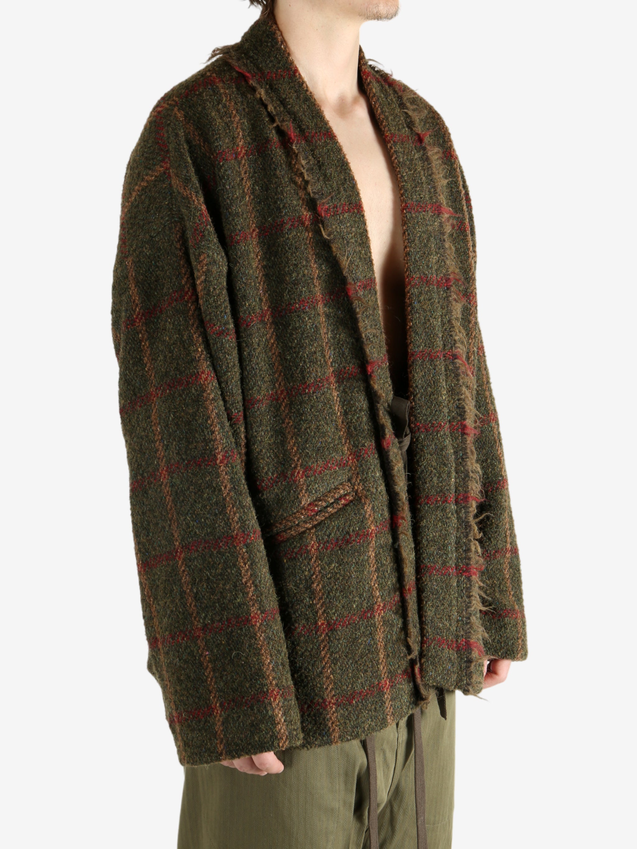 Green jacket worn by a person, showing the jacket's fit