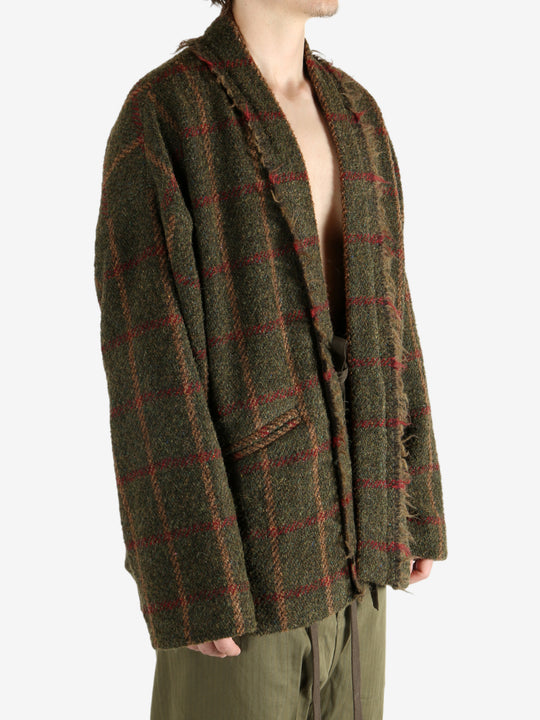 Green jacket worn by a person, showing the jacket's fit