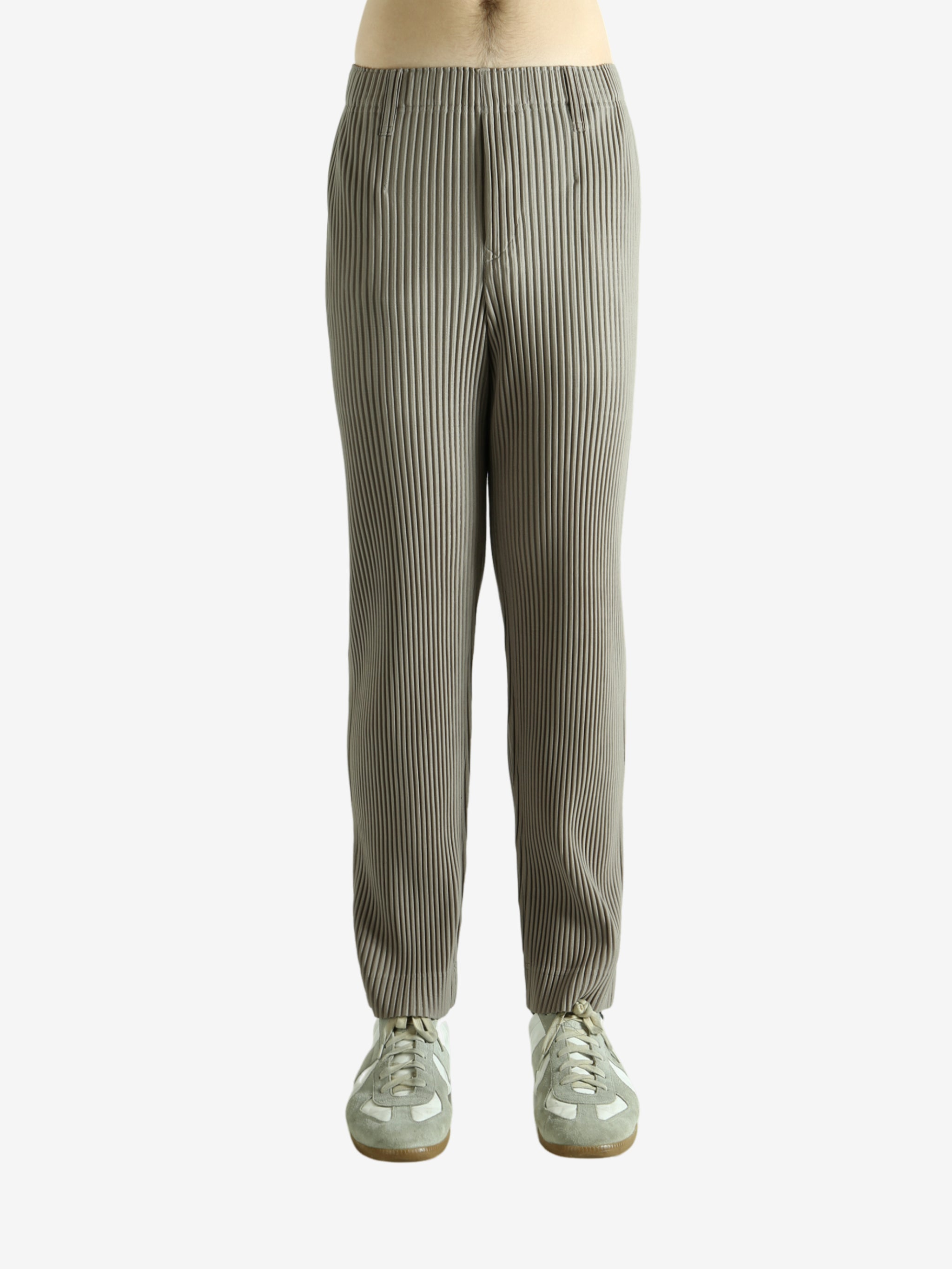 Grey pants worn by a person, showing the pants' fit