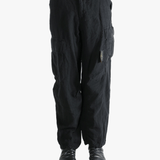 Black pants worn by a person, showing the pants fit