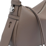 Close up of brown bag, showing the pin detail