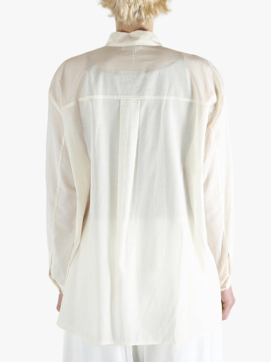 White shirt worn by a person, showing the shirt's fit