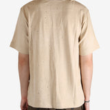 Tan t-shirt worn by a person, showing the t-shirt's fit