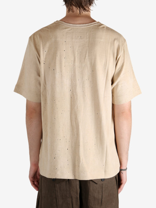 Tan t-shirt worn by a person, showing the t-shirt's fit