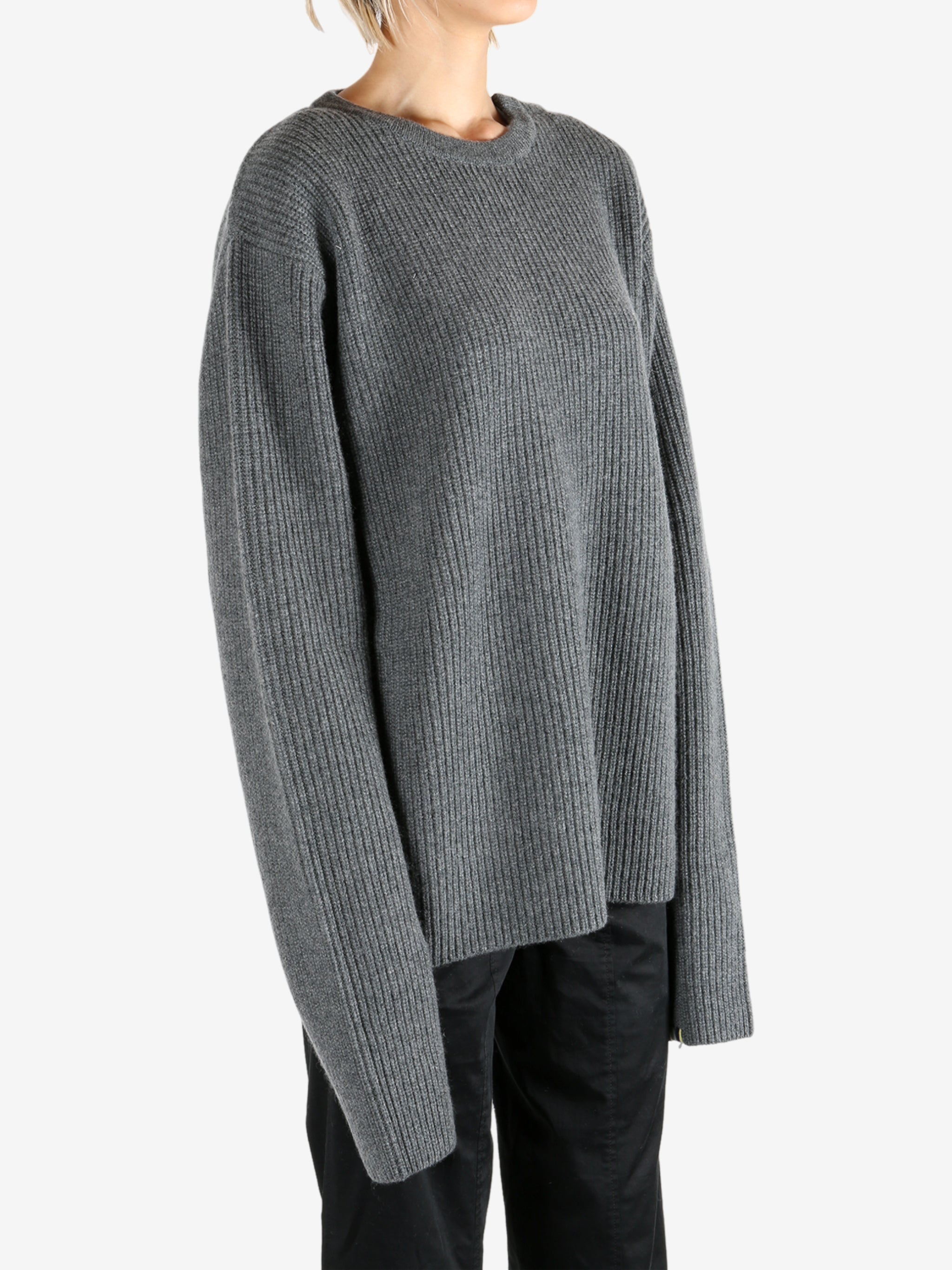 Grey knitwear worn by a person, showing the knitwear's fit