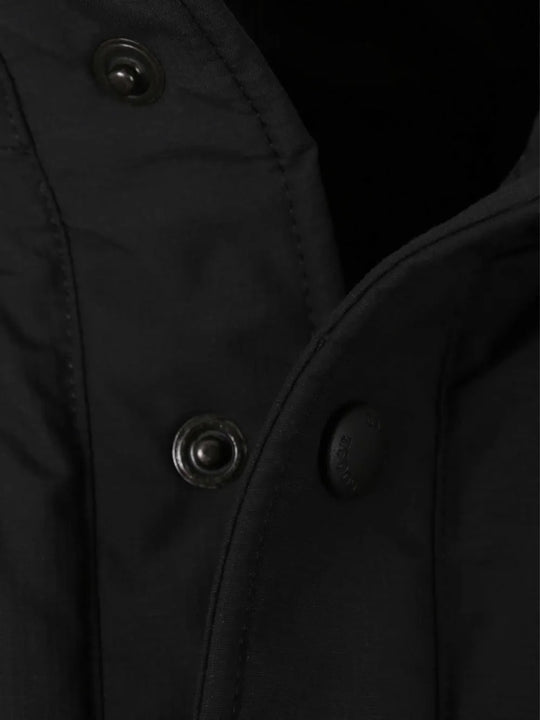 Close up of the black jacket, showing texture of the polyester fabric