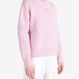 Pink hoodie worn by a person, showing the hoodie fit
