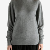 Grey knitwear worn by a person, showing the knitwear fit