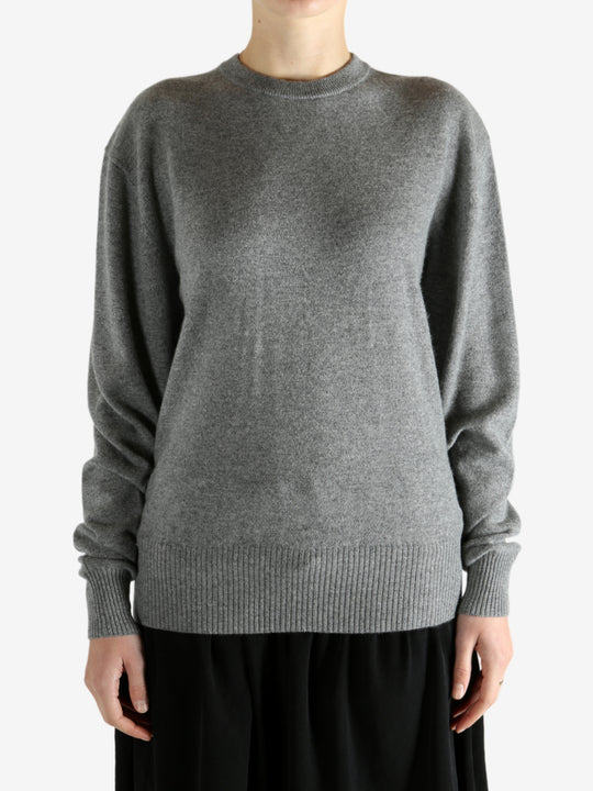 Grey knitwear worn by a person, showing the knitwear fit