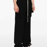 Black pants worn by a person, showing the pants fit