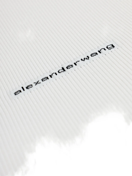 Close up of white t-shirts, showing texture of the cotton fabric